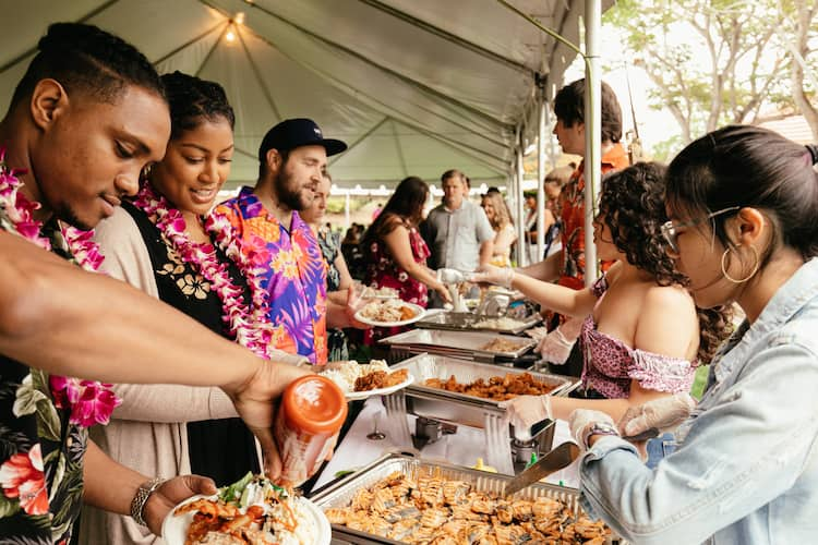 Past attendees enjoy authentic Hawaiian food